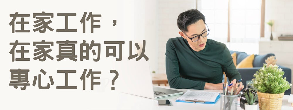 man with glasses studying at desk